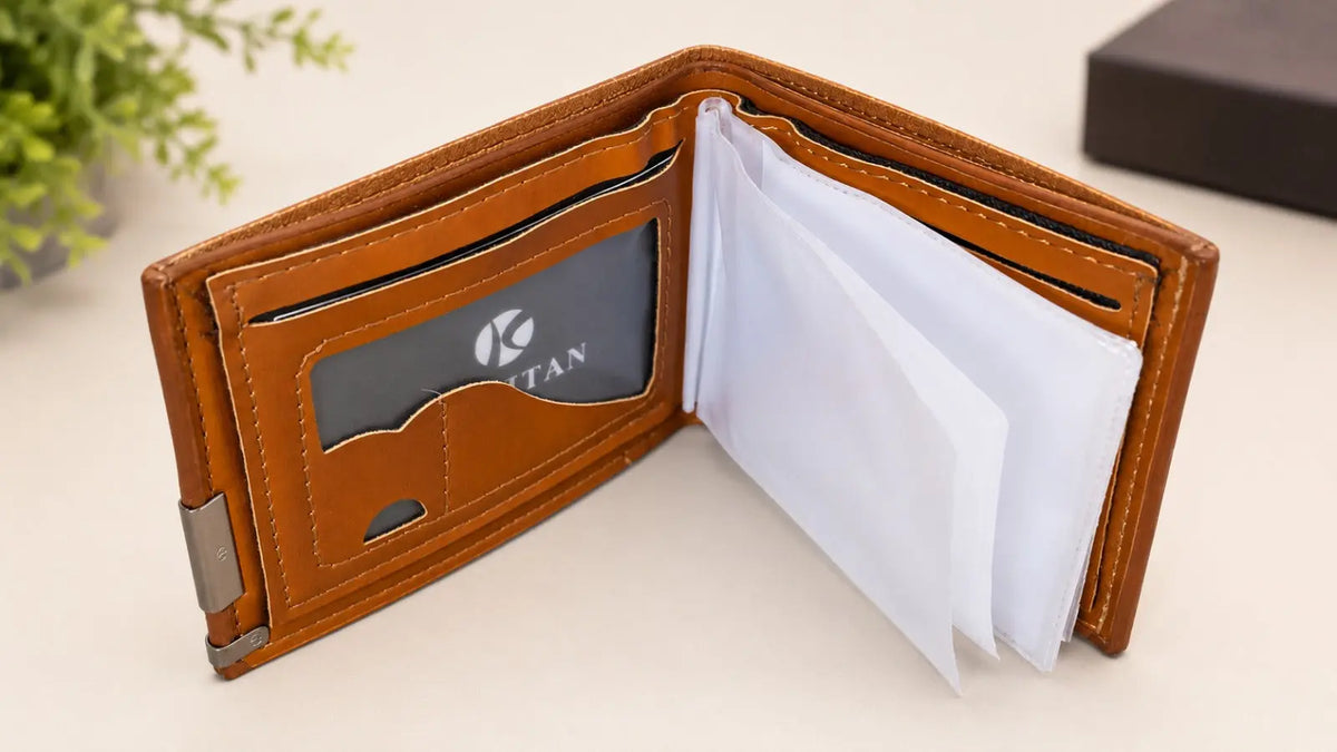 An open brown leather bifold wallet with card slots, a transparent ID window showing a card with the TIAN logo, and white paper inserts, photographed on a light beige surface.